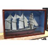 A scratch-built and hand-painted model ship with four mainsails and miniaturised detail including