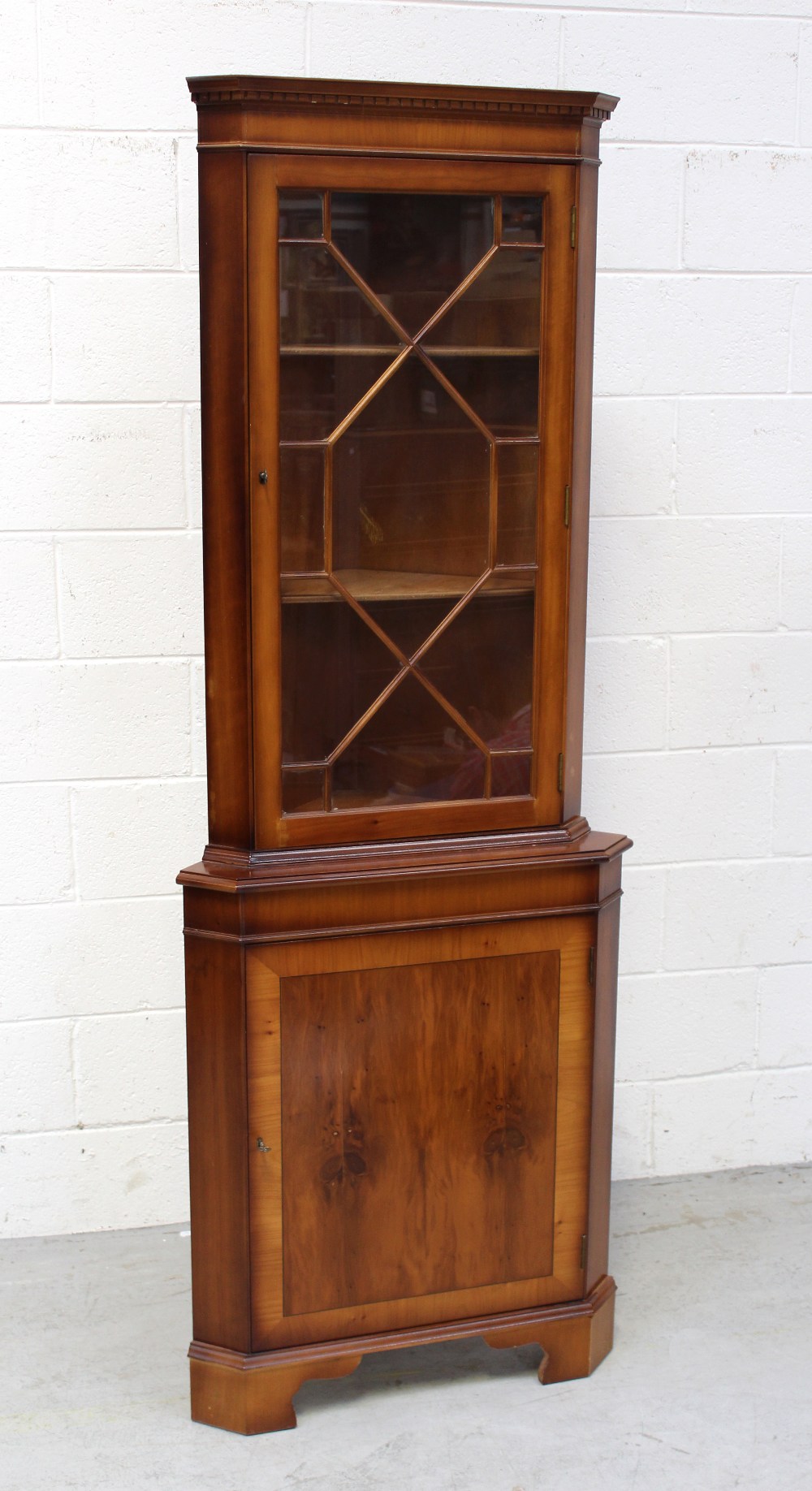 A reproduction yew wood corner cupboard, height approx 181cm.