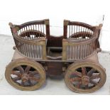 A tropical hardwood twin-seat dog cart with handworked copper panelling on eight-spoke