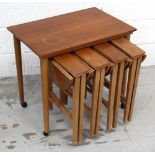 A retro nest of four tables on tapering supports, the largest with turned supports and castors.