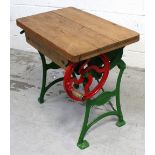 An early 20th century cast iron mangle, green painted base with pine wooden slat top,