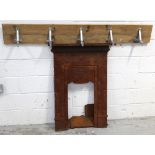 An Edwardian cast iron fire surround with Art Nouveau decoration (badly rusted) and a pine plank