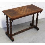 A late 19th/early 20th century walnut inlaid games table on bobbin-turned supports to cross