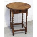 An early 20th century oak circular side table on wrythen supports and cross stretchers,