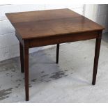 A mahogany fold-over table on tapering supports, length when extended 90cm.