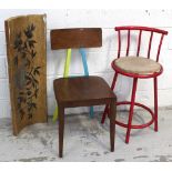 A tubular bar stool spray-painted in red gloss,