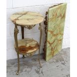 An onyx circular side table with lower shelf on gilt metal tapering supports,