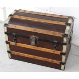 An early 20th century travel trunk with wood and brass band decoration, length 69cm.