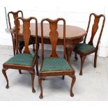 An early 20th century oak circular wind-out dining table on cabriole supports with shell kneecaps