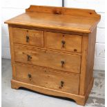 An Edwardian pine two-over-two chest of drawers, on a shaped plinth base, length 93cm.