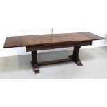 An early 20th century oak refectory-style draw-leaf dining table,