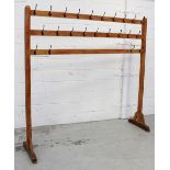 A freestanding pine three-rail hat/coat stand, originally from a church in Warrington, 192 x 200cm.