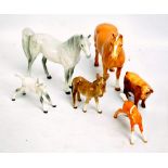 BESWICK; four horses including two dapple white examples, a donkey and a cow (6).