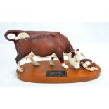 BESWICK; a Connoisseur model 'Hereford Cow & Calf' on wooden plinth, length of model approx 31cm.