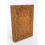 An Indian wooden card case with well carved decoration throughout, 12 x 8.3cm.