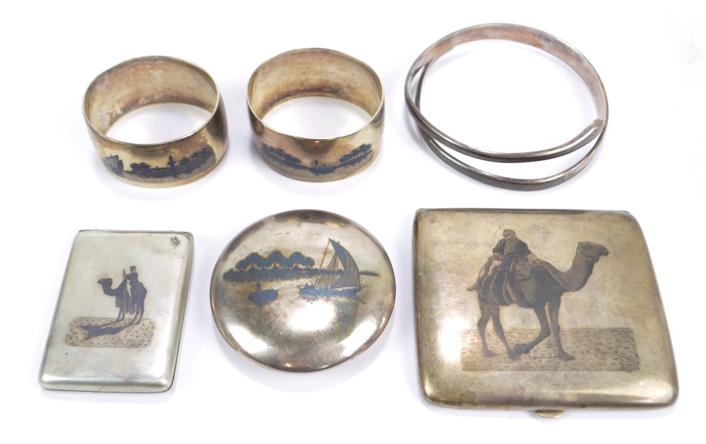 A group of various early 20th century Iraqi niello decorated white metal items comprising cigarette