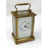 K J Bradford; a 20th century brass carriage clock, the enamel dial set with Roman numerals,