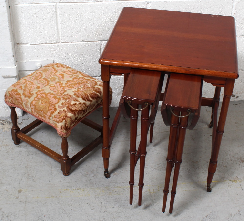 A contemporary nest of three mahogany tables on turned tapering supports and a small early-to-mid