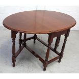 A reproduction mahogany drop-leaf dining table, length when extended 134cm.