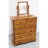 A contemporary pine two-over-four chest of drawers on bun feet and a contemporary pine swing