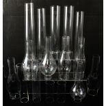 Sixteen glass paraffin lamp chimneys in various shapes, height of largest approx 33cm (16).