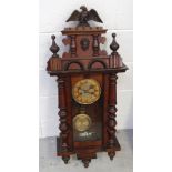An early 20th century mahogany Vienna-style wall clock with eagle finial to top above gilded dial