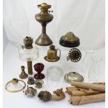 A collection of oil lamps to include a brass example with fluted column, height 52cm,