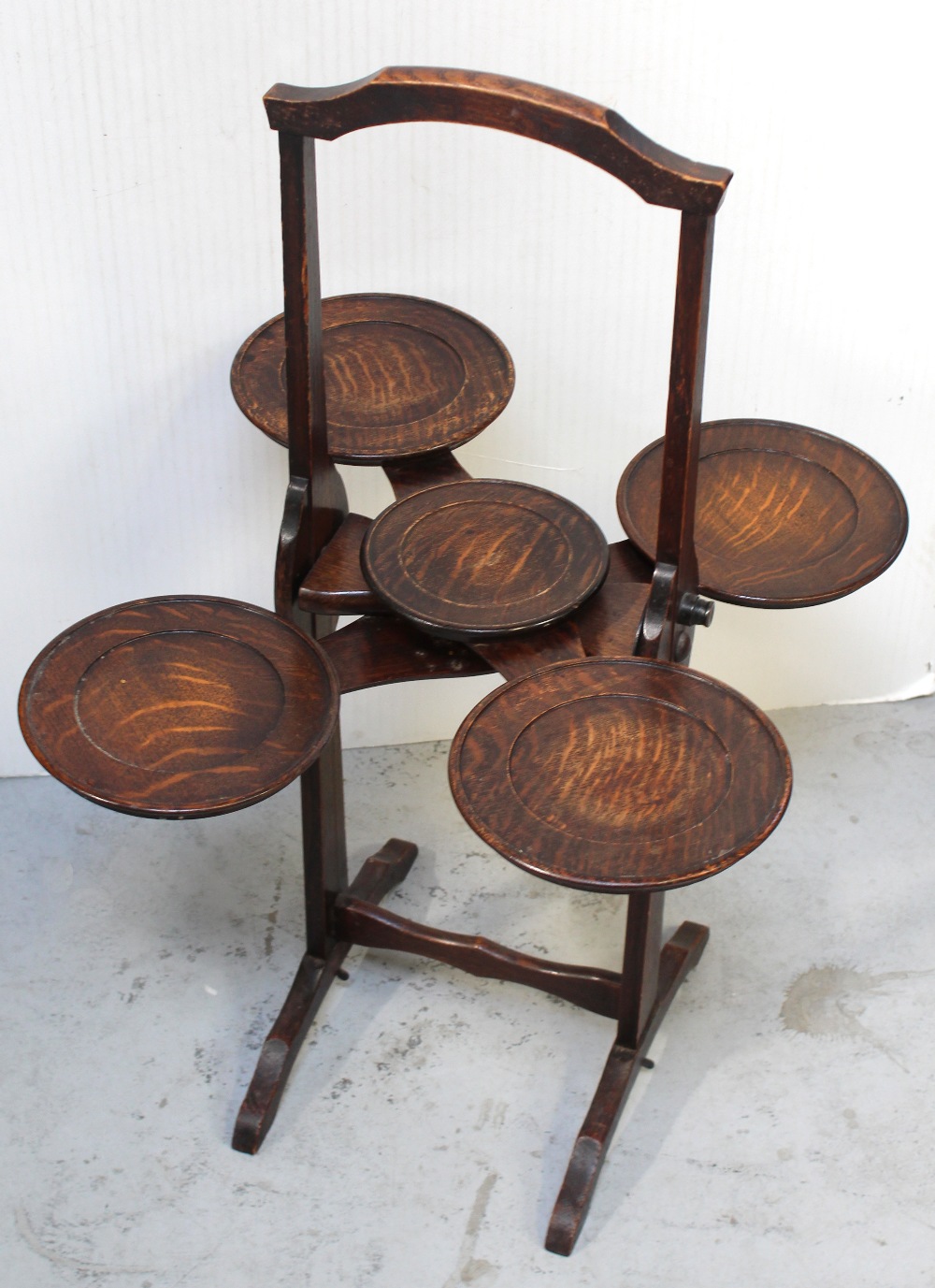 A Monoplane patented oak cake stand, height 76.5cm.