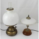 A retro electric table lamp in the form of and old paraffin lamp and a smaller electric table lamp