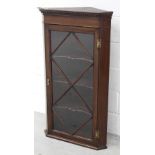 An early 20th century mahogany wall-hanging corner unit with three interior shelves, height 104cm.