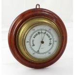A ship's style brass barometer on a stepped mahogany base, dial 17cm.