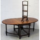 A mid-20th century oak oval draw-leaf gate-leg dining table on wrythen turned supports and cross