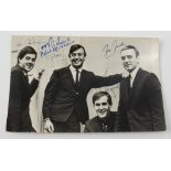 A signed photograph of Gerry and the Pacemakers, including Gerry and Fred Marsden,