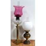 An early 20th century brass oil lamp with opaque glass shade and an early 20th century oil lamp,