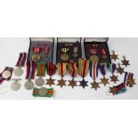 A collection of WWII medals to include a group of four with certificate of issue comprising war and