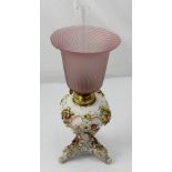 A Sitzendorf gilt and floral-encrusted porcelain oil lamp with fluted pink glass shade, height 40cm.