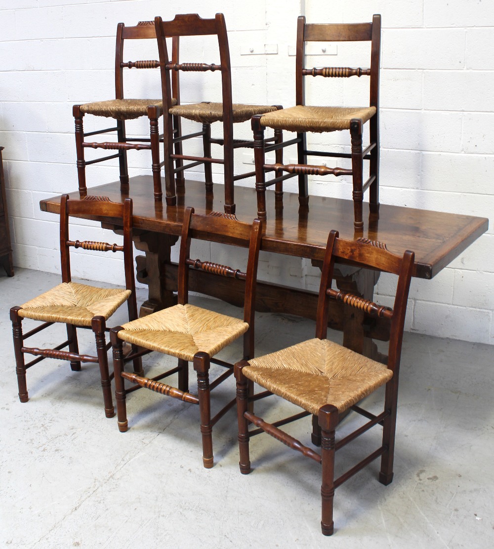 A late 19th/early 20th century refectory-style rectangular dining table on slab-end supports and