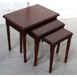 A nest of three mahogany tables on turned tapering supports.