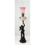 A spelter and brass figural oil lamp modelled as a fairy, signed 'Rancoule' to base,