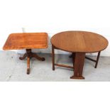 An oak circular drop-leaf table of small proportions on gate-leg support and small side table on