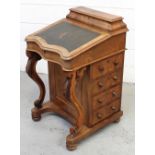 A Victorian walnut Davenport with lidded stationery compartment and serpentine-fronted sloping top,