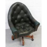 A button-back leather swivel armchair.