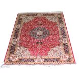 A red ground Keshan carpet,