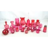 A quantity of cranberry glass including two jugs, a large bell, a set of beakers,