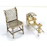 A late 19th/early 20th century Chinese Export silver miniature chair with mesh seat and ring turned