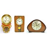 A stained beech and brass mounted wall clock with circular dial set with Roman numerals,