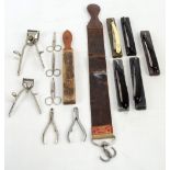 A small collection of vintage straight razors complete with wooden and leather strops,