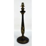 A chinoiserie black lacquered and gilt heightened table lamp decorated with landscapes,