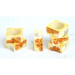 CLARICE CLIFF; a set of six 'Rhodanthe' pattern square sectioned napkin rings, each width 5cm.