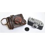 LEICA; a leather cased camera, no.56109304, with spurious engraved Third Reich detail.